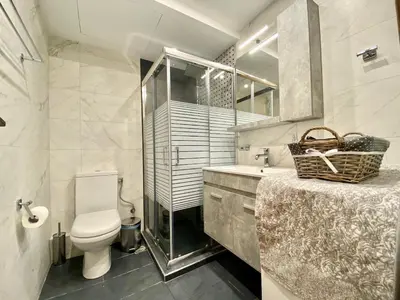 a bathroom with a toilet and a sink and a mirror at Glyfada SEASIDE South Athens Philoxenia In Athens in Athens