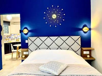 a bedroom with a blue wall with a white bed at Glyfada SEASIDE South Athens Philoxenia In Athens in Athens