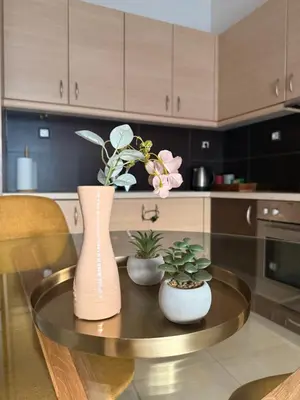 a kitchen with a table with vases and plants on it at ArtemisAth in Athens