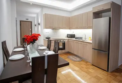a kitchen with a dining table and a refrigerator at Charming Apt Near Athens Museum! in Athens