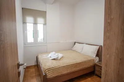 a bedroom with a bed with towels on it at Charming Apt Near Athens Museum! in Athens