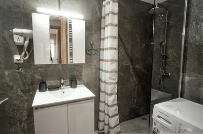 a bathroom with a sink and a shower at Charming Apt Near Athens Museum! in Athens