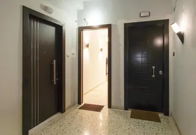 a hallway with two black doors and a hallway with at Charming Apt Near Athens Museum! in Athens