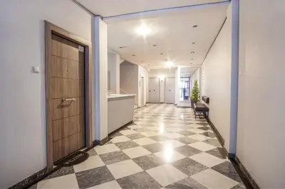 a hallway with a door and a checkered floor at Charming Apt Near Athens Museum! in Athens