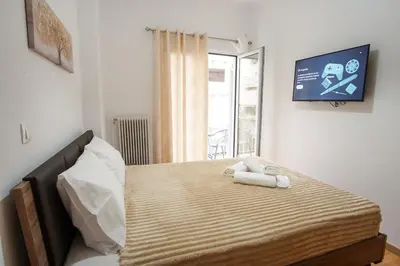 a bedroom with a bed with two towels on it at Charming Apt Near Athens Museum! in Athens