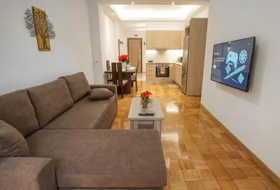 a living room with a couch and a table at Charming Apt Near Athens Museum! in Athens
