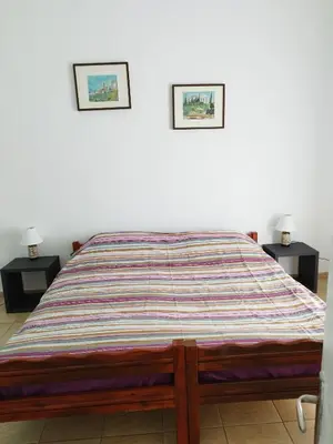 a bed in a room with two pictures on the wall at Rental room pilika4 in Athens