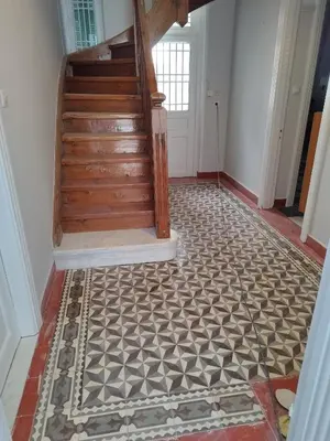 a hallway with a tile floor and stairs at Rental room pilika4 in Athens