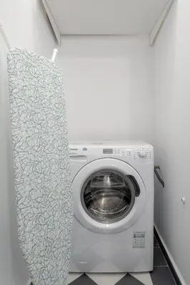 a washer and dryer in a white laundry room at Unique apartment next to Acropolis and metro in Athens