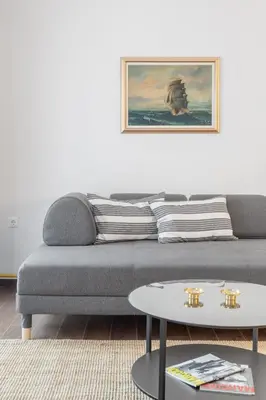 a living room with a gray couch and a table at Unique apartment next to Acropolis and metro in Athens
