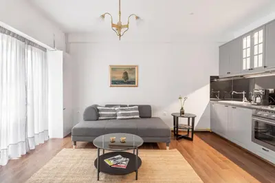 a living room with a couch and a table at Unique apartment next to Acropolis and metro in Athens