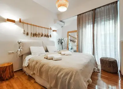 a bedroom with a large bed with two pillows on it at Stunning apartment next to Acropolis and metro in Athens