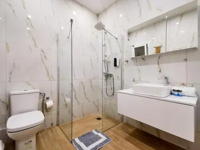 a bathroom with a toilet and a sink and a shower at Stunning apartment next to Acropolis and metro in Athens