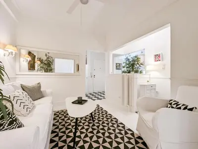 a white living room with a white couch and a table at Chessboard styled 2BD apt next to Acropolis&Metro in Athens