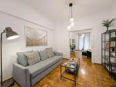 a living room with a couch and a table at Spacious apt for 5 guests next to Acropolis&metro in Athens