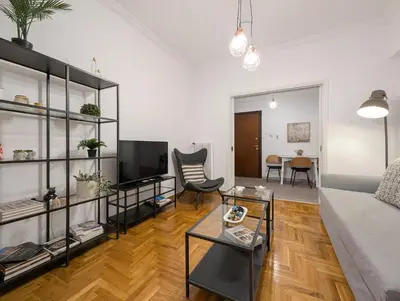 a living room with a couch and a table at Spacious apt for 5 guests next to Acropolis&metro in Athens