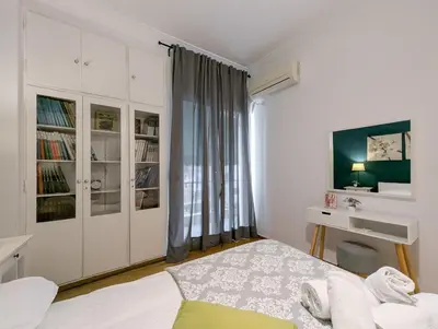a white bedroom with a bed and a window at Spacious apt for 5 guests next to Acropolis&metro in Athens
