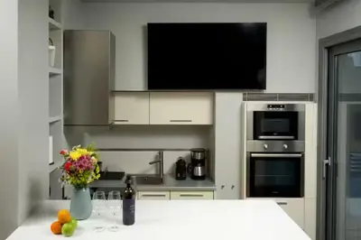 a kitchen with a counter with a vase of flowers at Modern apartment with Great view in Athens