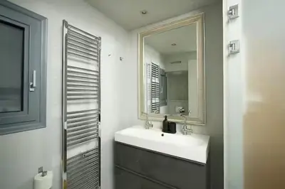 a bathroom with a sink and a mirror at Modern apartment with Great view in Athens