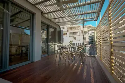 a balcony with a table and chairs on a deck at Modern apartment with Great view in Athens