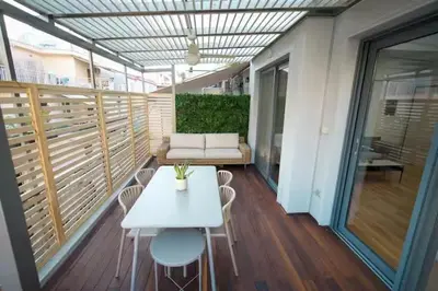 a white table and chairs on a balcony at Modern apartment with Great view in Athens