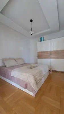 a bedroom with a large bed in a white room at Athens Riviera Bee Home Appartments in Athens