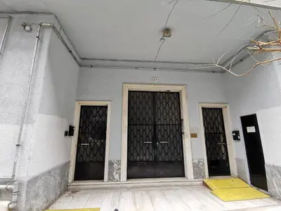 two entrances to a building with two black doors at \u7ef4\u591a\u5229\u4e9a\u516c\u5bd3 in Athens