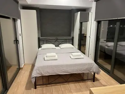 a bedroom with a bed with two towels on it at Kolokotroni Apartment in Piraeus