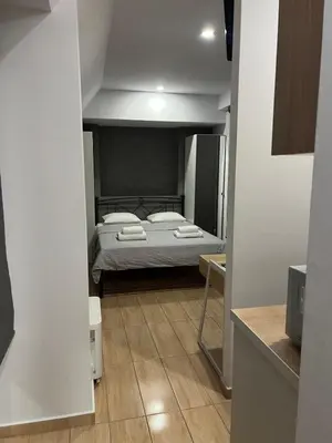 a bedroom with a bed in the middle of a room at Kolokotroni Apartment in Piraeus
