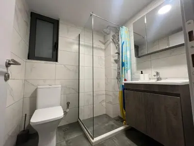 a bathroom with a shower and a toilet and a sink at Kolokotroni Apartment in Piraeus