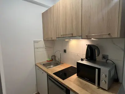 a small kitchen with a sink and a microwave at Kolokotroni Apartment in Piraeus