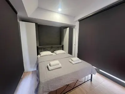 a bedroom with a bed with two towels on it at Kolokotroni Apartment in Piraeus