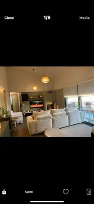 a living room with white couches and a living room with a couch at Ourania26! in Glyka Nera