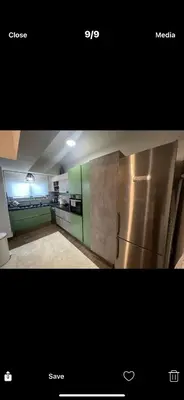 a kitchen with a stainless steel refrigerator in a room at Ourania26! in Glyka Nera