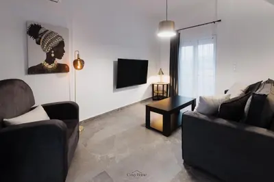 a living room with two couches and a television at Cosy Home Thissio in Athens