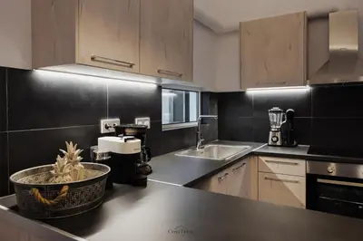 a kitchen with a sink and a counter top at Cosy Home Thissio in Athens