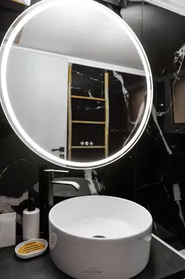 a bathroom with a white sink and a mirror at Cosy Home Thissio in Athens