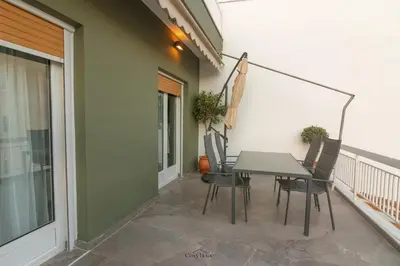 a patio with a table and chairs on a balcony at Cosy Home Thissio in Athens