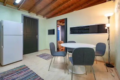 a kitchen with a table and chairs and a refrigerator at Monastiraki metro st 1 bedroom apt for 2 by MPS in Athens