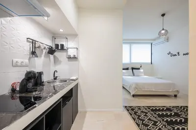 a kitchen with a sink and a bed in a room at Syrou 1834 in Athens
