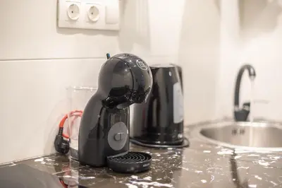 a mixer sitting on a counter next to a sink at Syrou 1834 in Athens