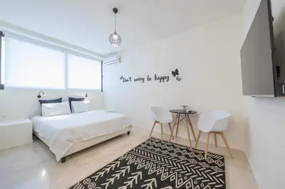 a bedroom with a bed and a black and white rug at Syrou 1834 in Athens