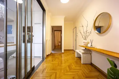 a hallway with wood floors and a mirror at Cozy Apartment - Best Location in Athens in Athens