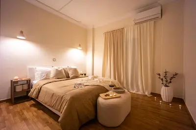 a bedroom with a large bed and a vase of flowers at Cozy Apartment - Best Location in Athens in Athens