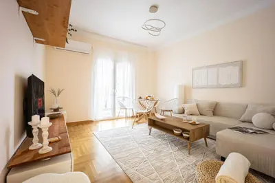 a living room with a couch and a table at Cozy Apartment - Best Location in Athens in Athens