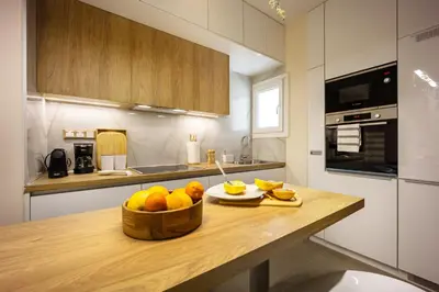 a kitchen with a table with a bowl of fruit on it at Cozy Apartment - Best Location in Athens in Athens