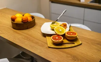 a wooden table with oranges and a bowl of fruit at Cozy Apartment - Best Location in Athens in Athens