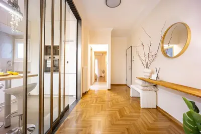 a bathroom with a wooden floor and a mirror at Cozy Apartment - Best Location in Athens in Athens