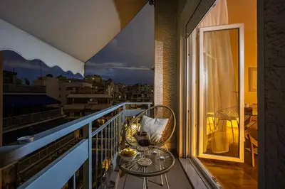 a balcony with a table and a view of a city at Cozy Apartment - Best Location in Athens in Athens