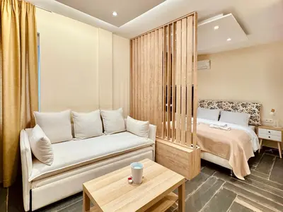 a living room with a couch and a bed at Ermou 18 Central Cozy Apartment in Athens
